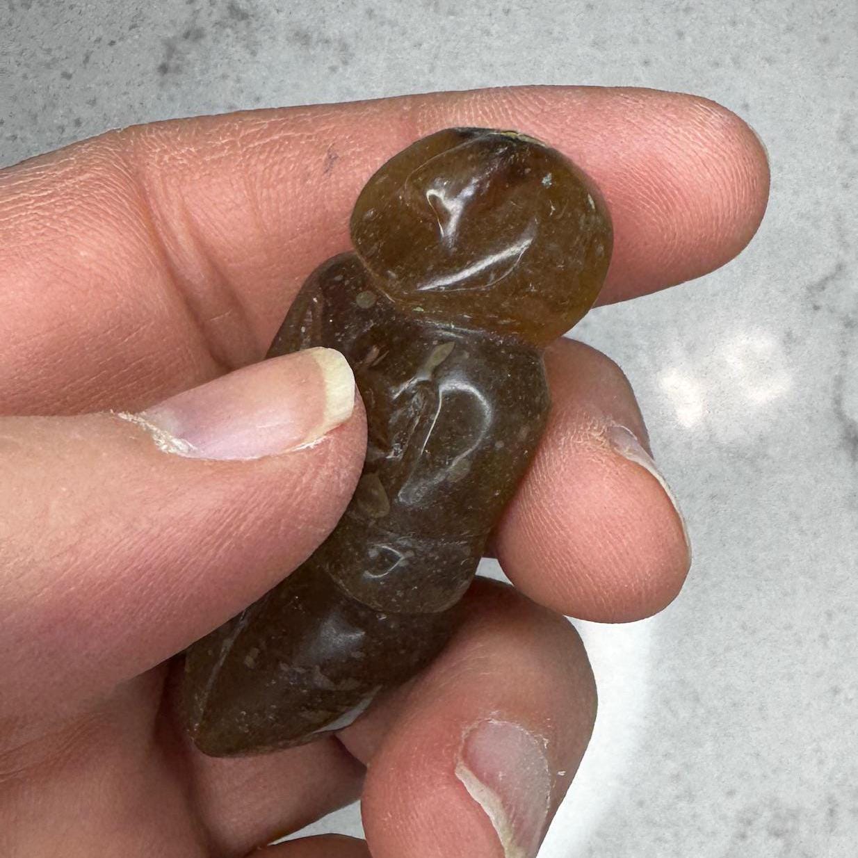 Beautiful smooth, honey amber goddess carving from Artifactual.
